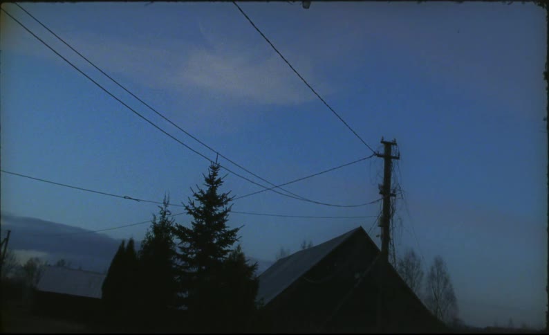 Power lines hang close to the rooftop of a home