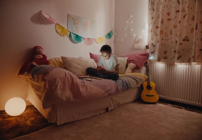 Timelapse of a girl sitting on a couch writing in a notebook and using a phone and standing and walking around with the phone