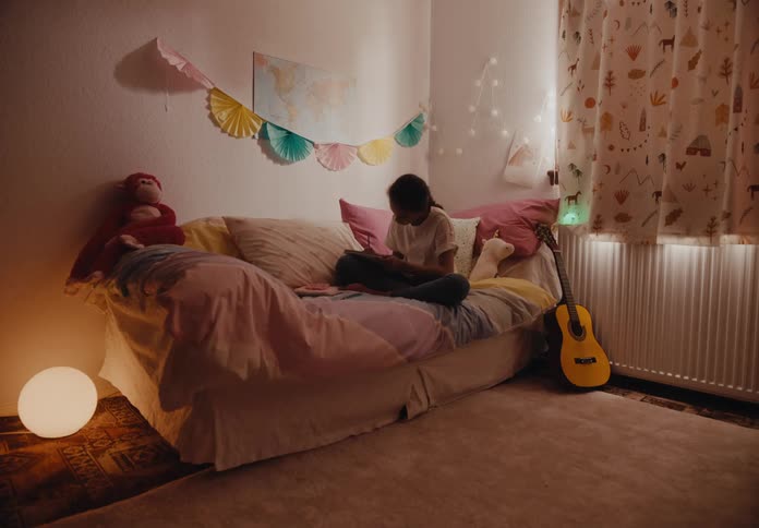 Timelapse of a child playing with a smartphone and guitar