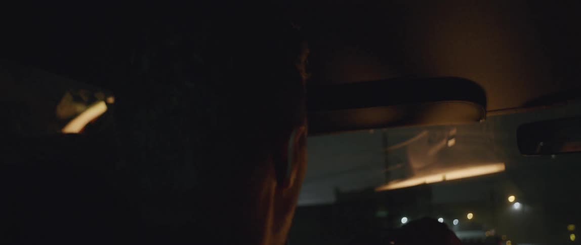 A man driving through a city at night
