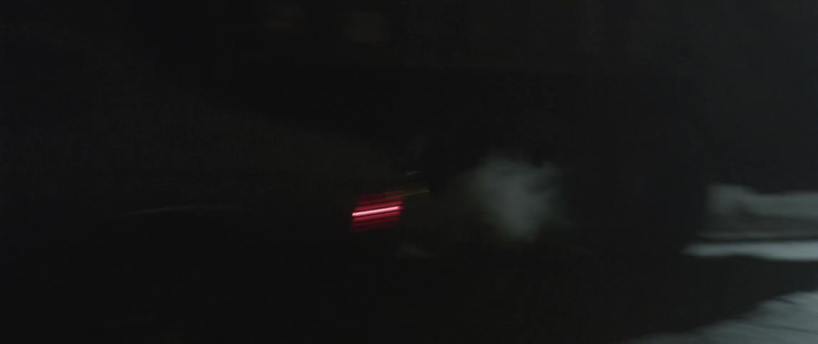A car speeds by at night