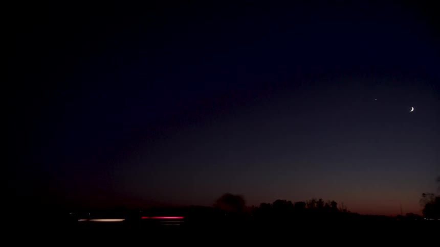 Cars are driving outside outdoors at night time