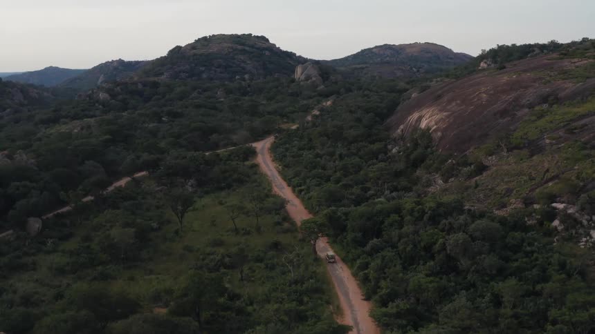A vehicle travels on the road on the hills