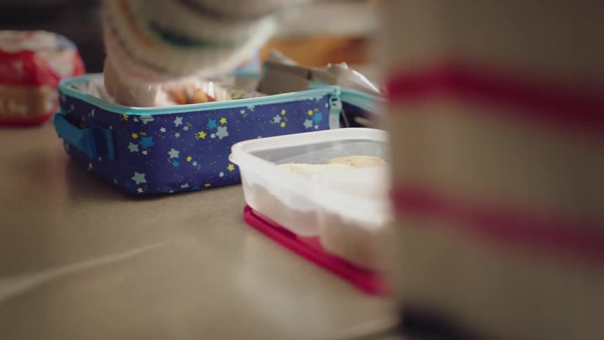 Food is being placed in a lunchbox
