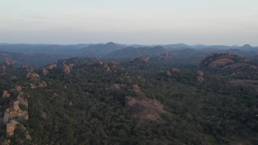 The view is of the wilderness and you can mountains in the distance