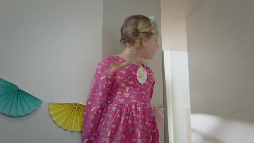A girl is playing indoors in the house