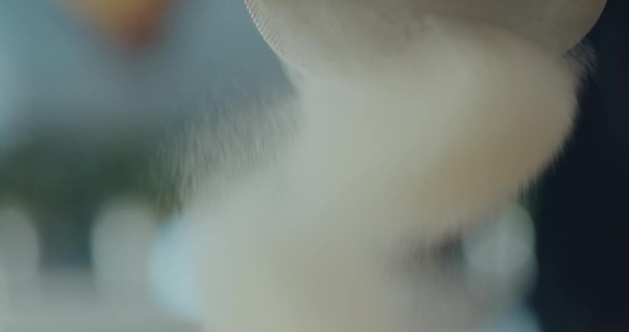 A man sifting flour