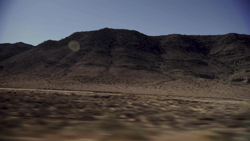 Shipping trucks are driving through a wilderness area