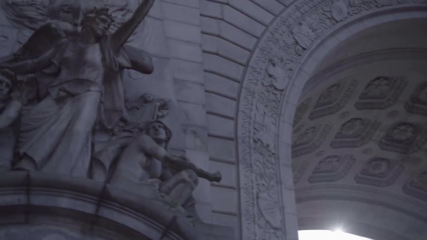 Sculptures on the face of an arched structure at daytime