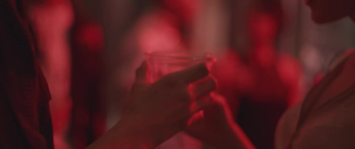 A woman talks and toasts the person in front of her
