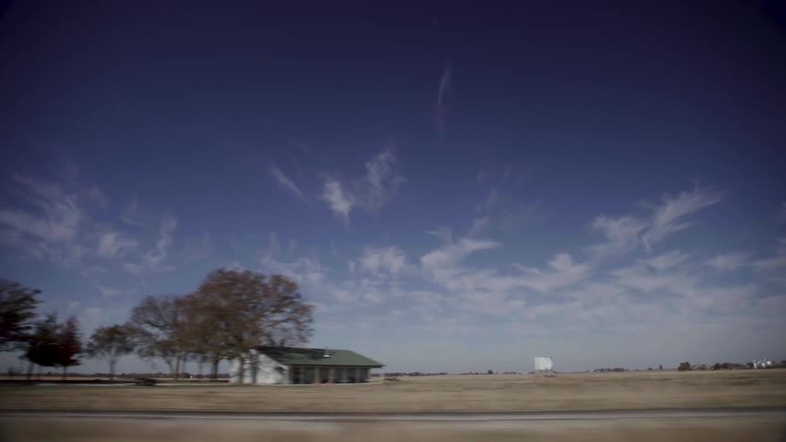 A rural home surrounded by fields in the daytime