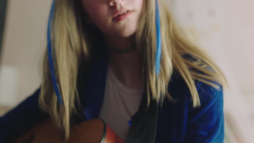 A girl is playing the guitar