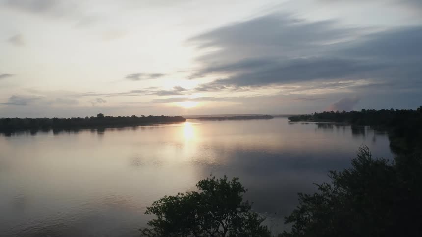 Aerial view of the sun reflected on a tranquil river