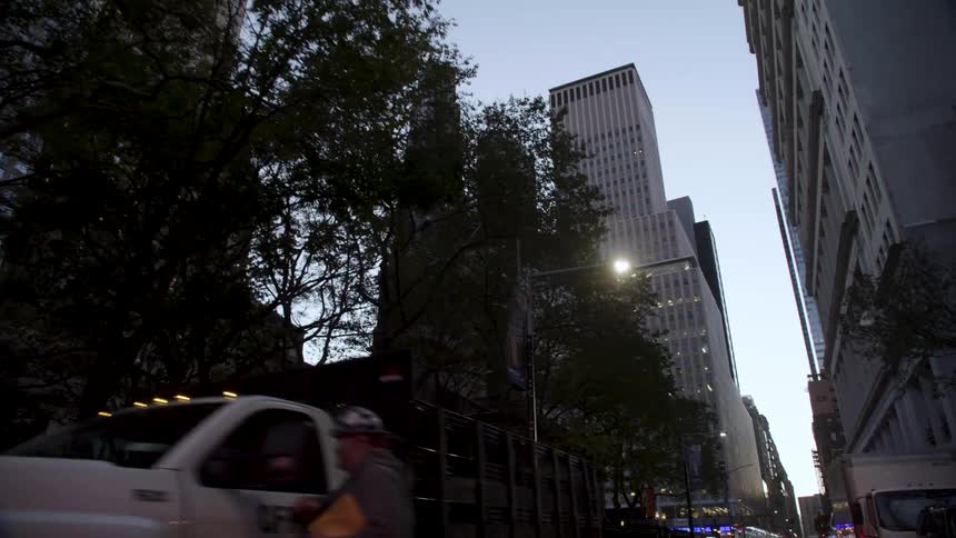 Cars in a downtown city are parked on the street