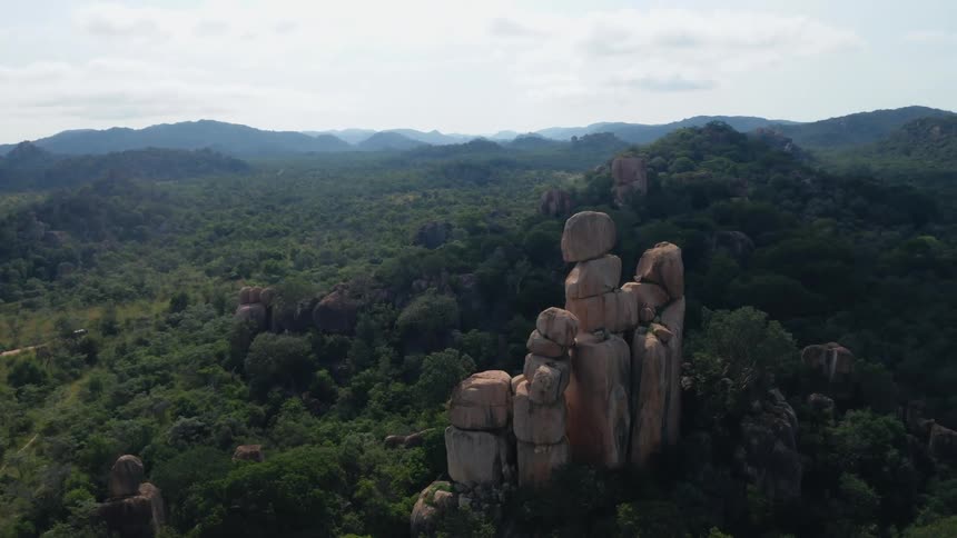 Aerial view of stacked rock outcroppings in lush jungle landscape