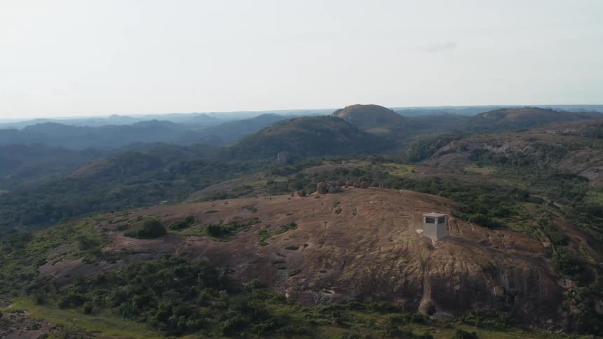 Aerial view of a building in the wilderness is displayed