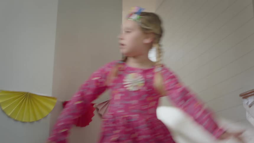 A young girl playing hide and seek at a home birthday party
