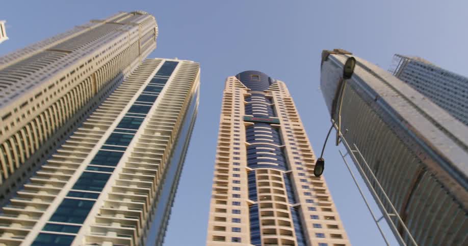 Tall buildings line the clear sky