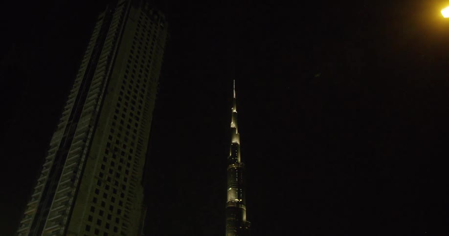 Building lights of downtown skyscrapers contrast with the night sky