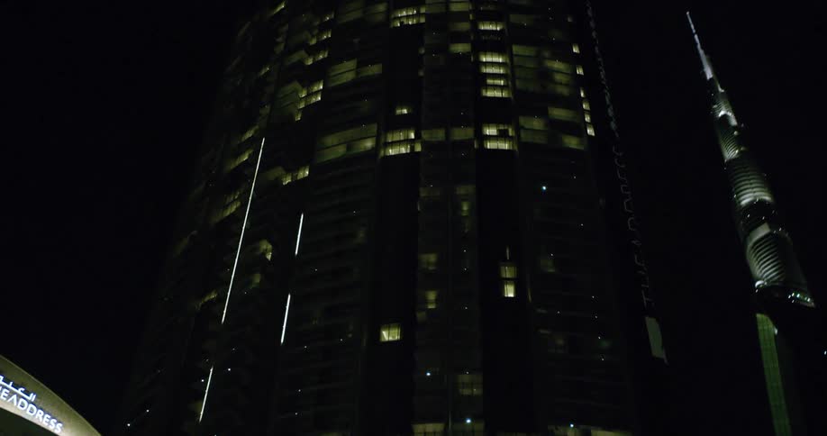 The tall buildings are lit at night