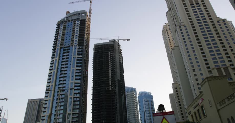 Construction cranes on top of skyscrapers in dubai