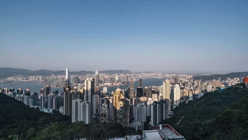 A view of hong kong from victoria peak with boats moving through the harbor