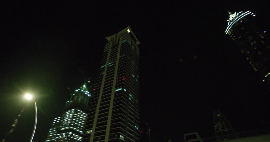 A train runs on elevated tracks past downtown