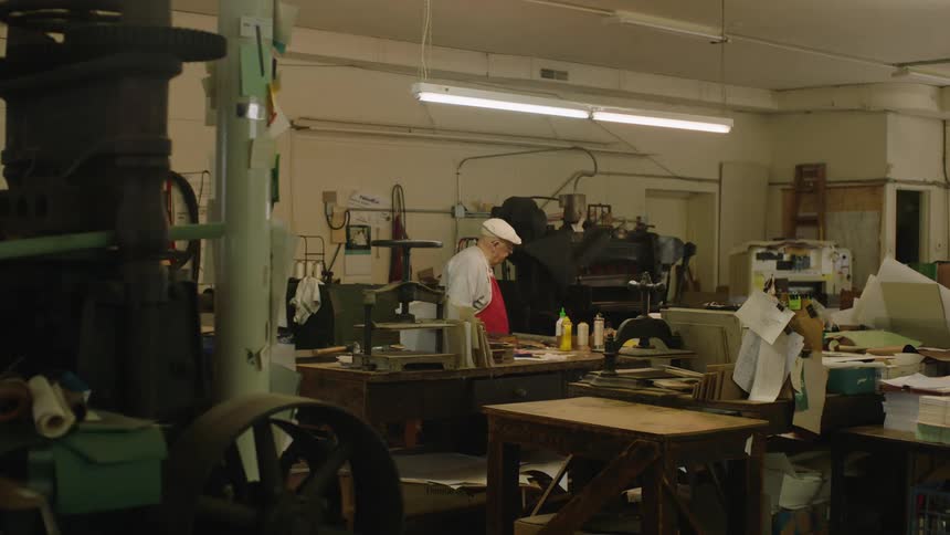 A man stands in the workshop of a business
