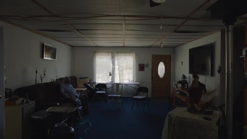 A man is sitting on the couch in an old home