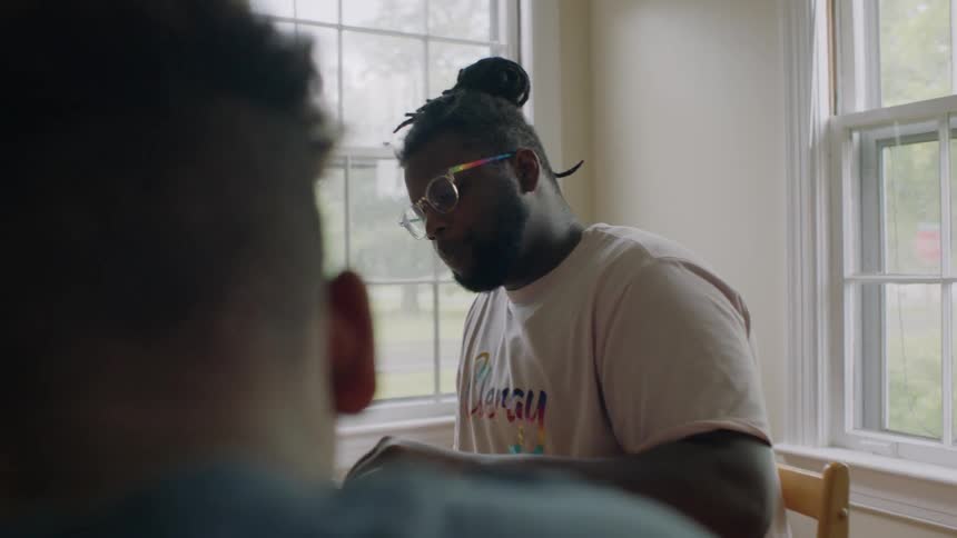 Three young men have a meal at home together
