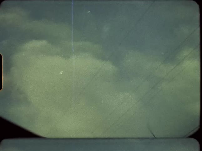 Power lines run between poles under a cloudy sky