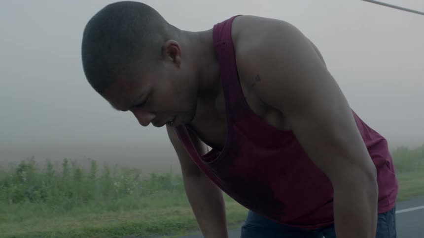 Jogger catches his breath on a foggy country road