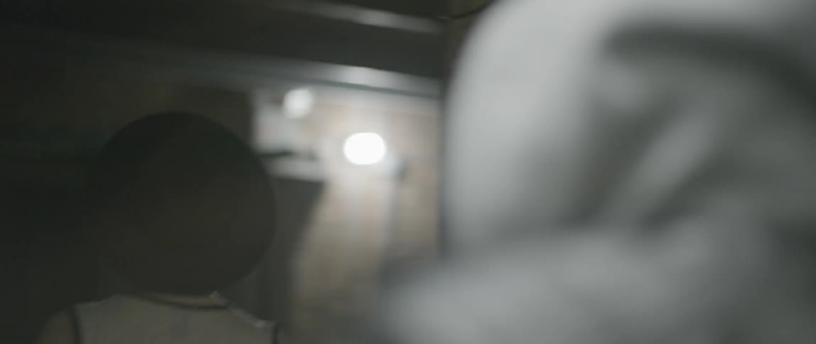 A man following a woman down a hallway