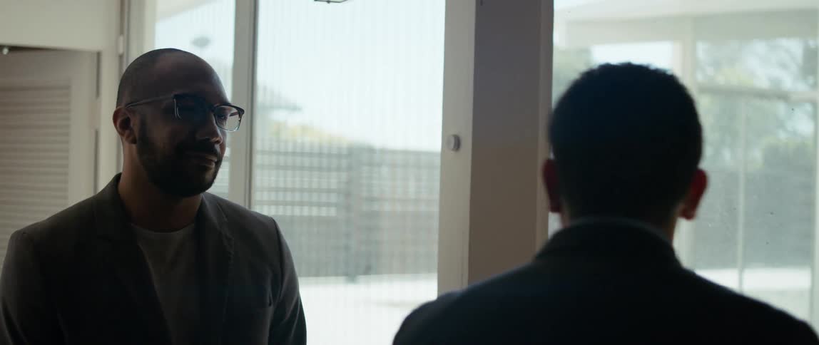 A realtor shows a man around a house