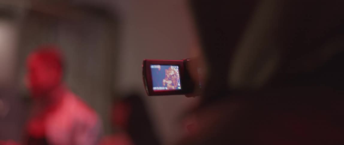 A person films a group of people