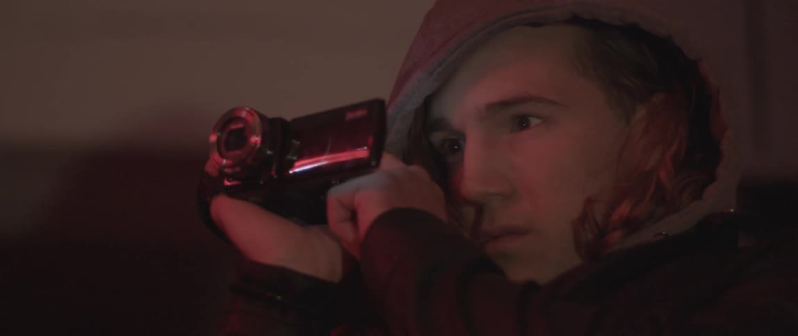 A man watching the screen on his camcorder