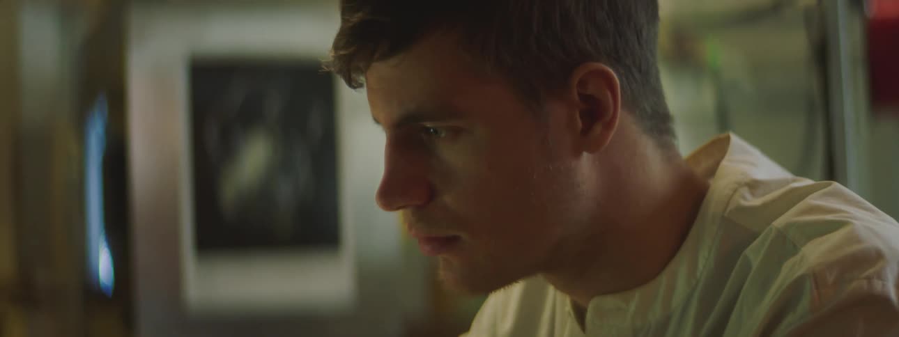 A man is sitting in a room and looking at something