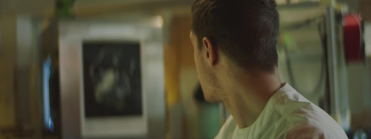 A man is sitting in a room and looking at something