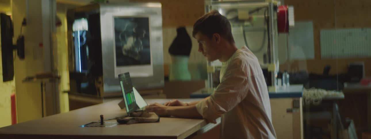 A man is typing on his laptop