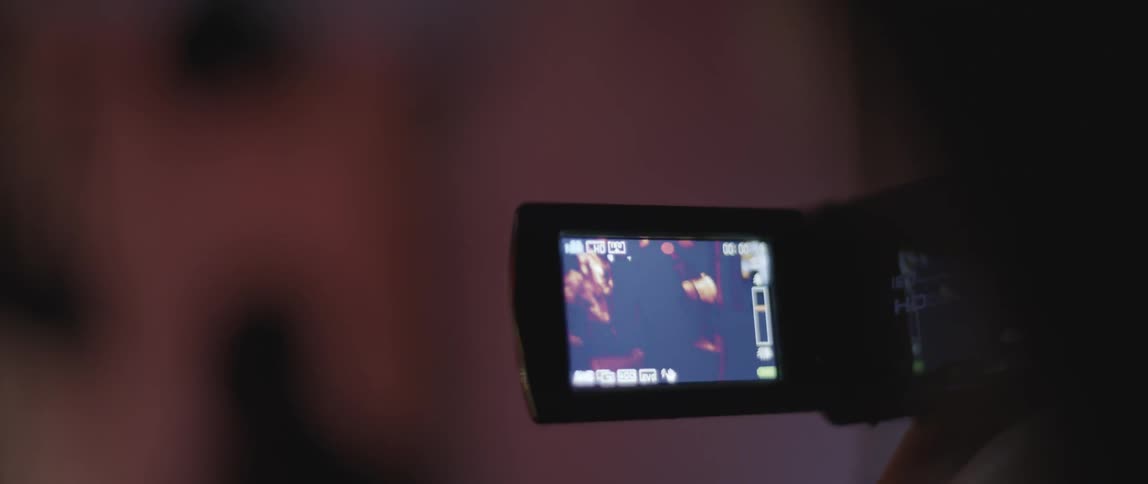 A person videotapes a party