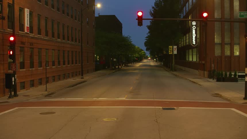A city street through a neighborhood is empty at night