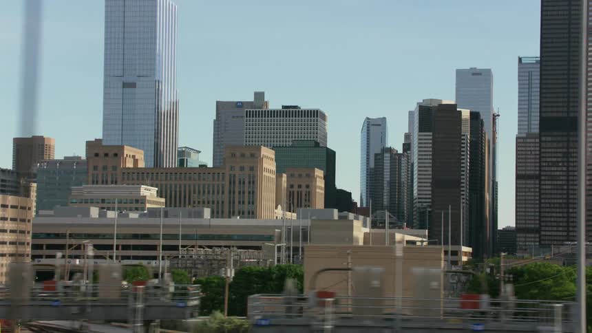 A view approaching a city with a lot of tall buildings