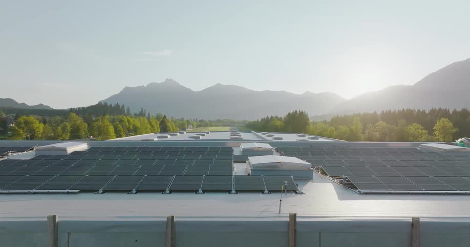 Solar panel power generation above a small town with hills and mountains