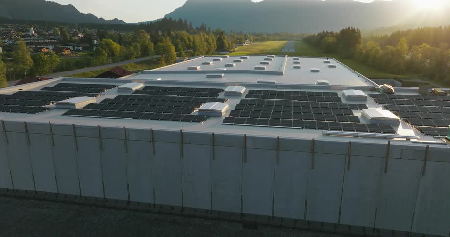 Solar panels cover the roof of a large factory