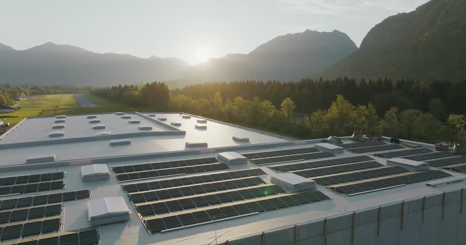 A government installation with a runway is nestled amongst trees in a mountainous area