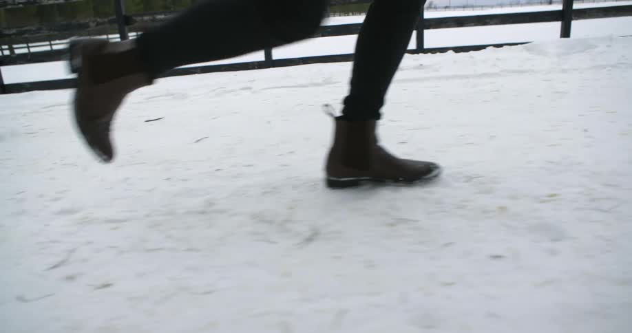 A person runs on a snow covered path
