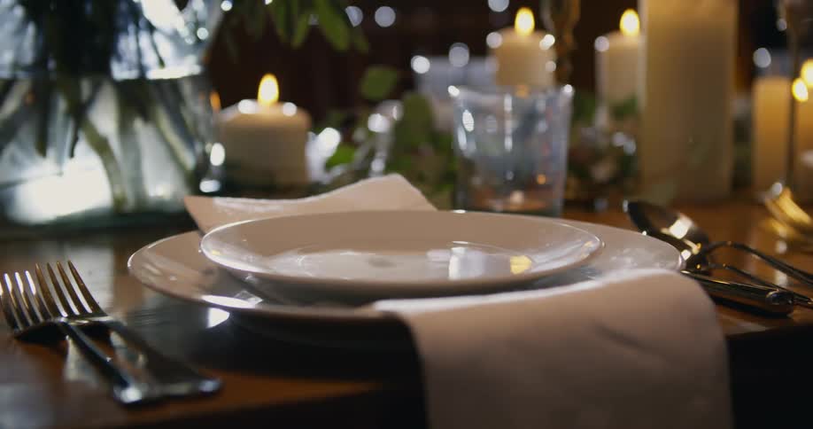 A person arranges plates on a table