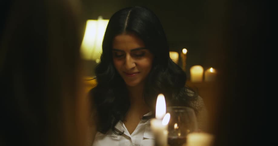A woman smiles with her eyes closed