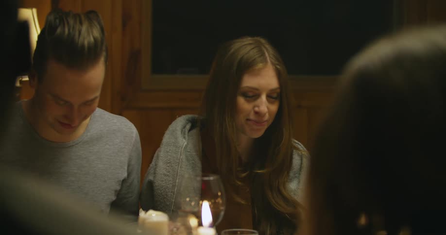People nodding and laughing at a table
