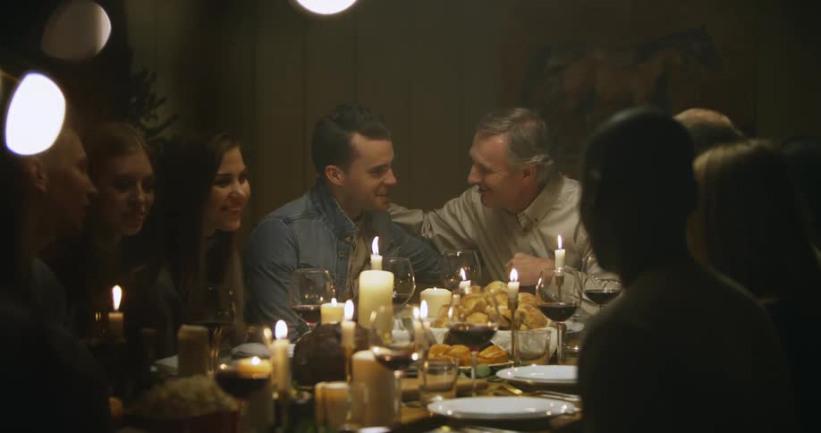 A family is sitting down to a meal at a table